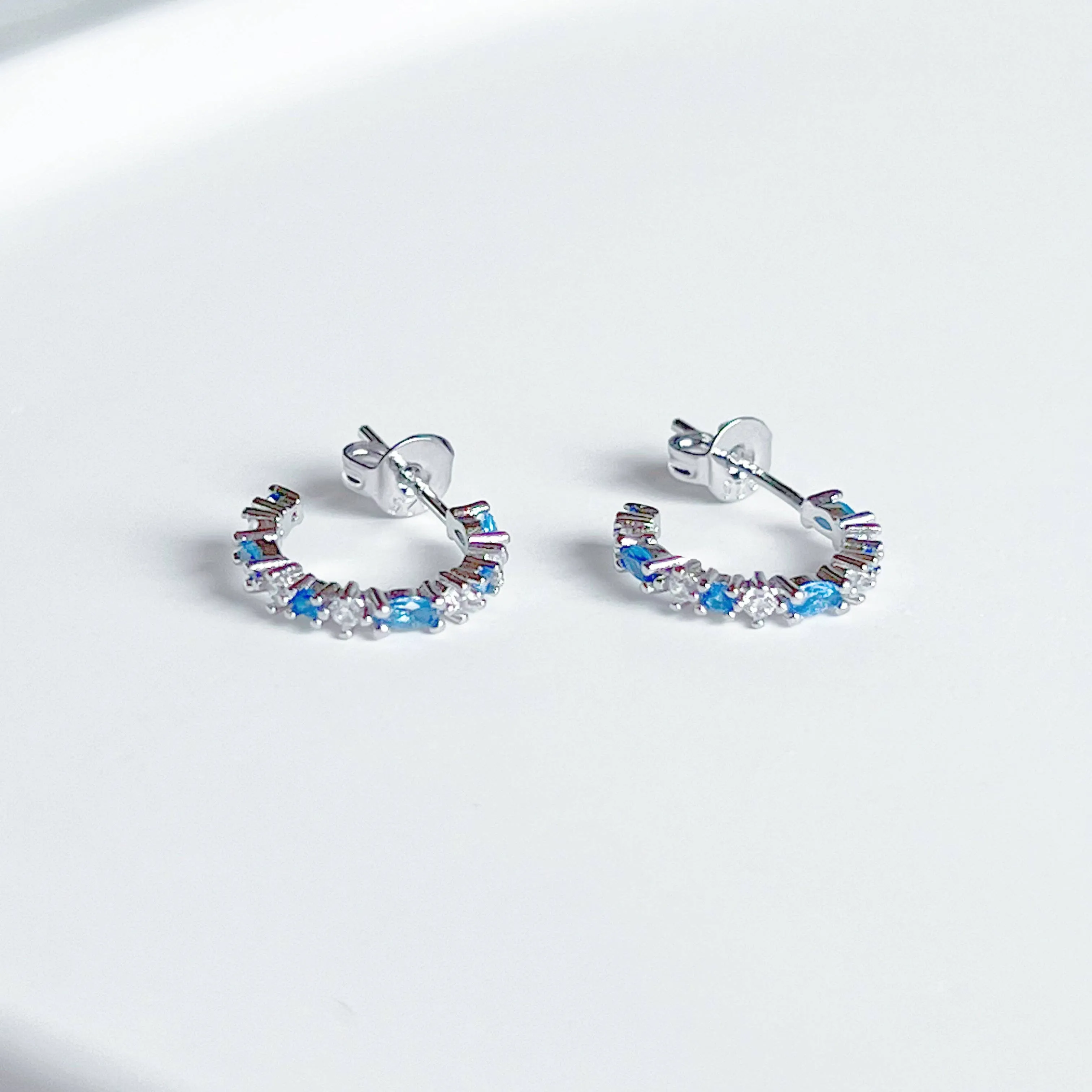 Ninaouity - Silver Blue Topaz Mini Hoop Earrings - December Birthstone