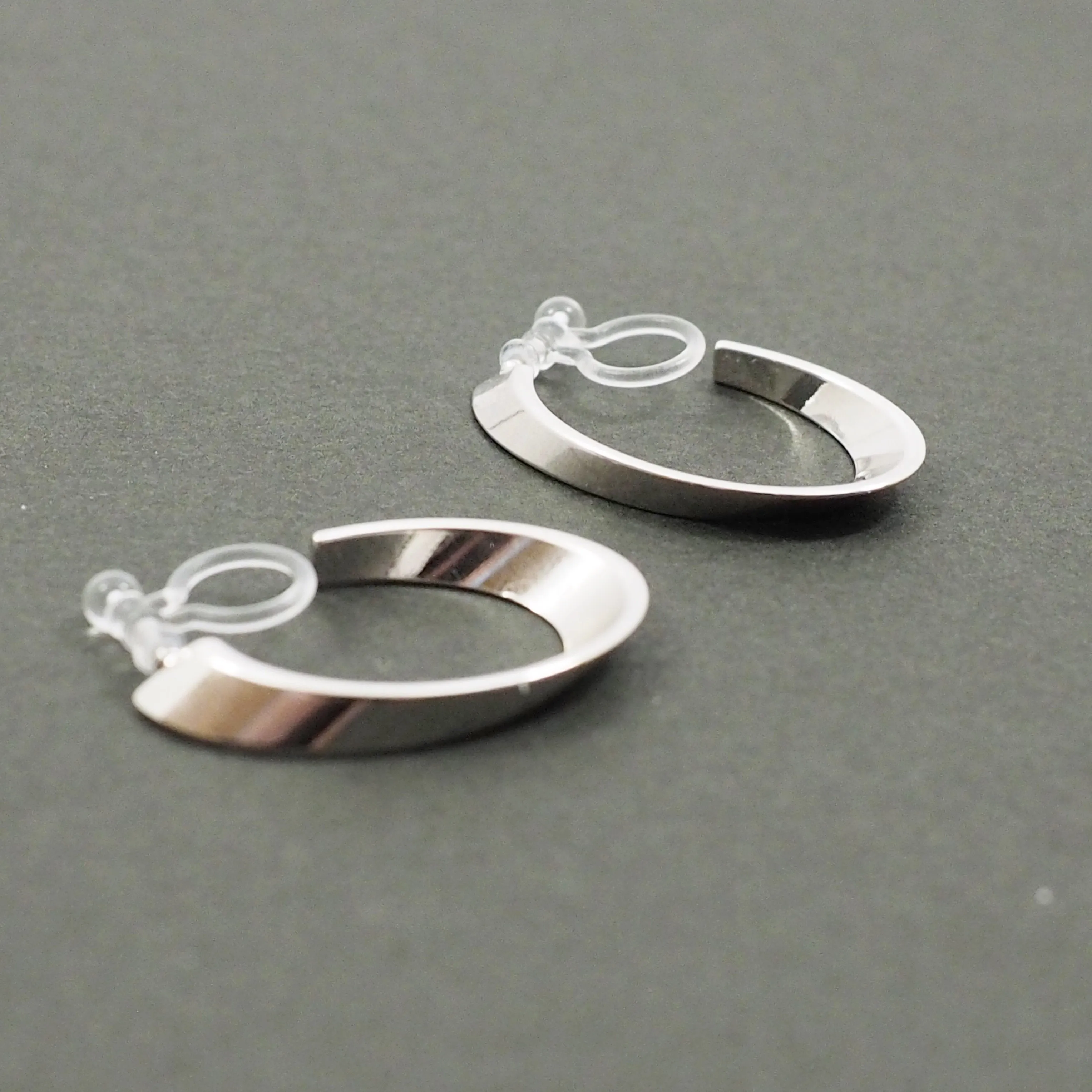 Silver Twisted Oval Invisible Clip On Hoop Earrings